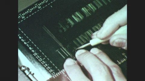1950s: Close up, hands trace letters on stencil. Hands put illustration under Stock Footage 85828540