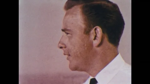 1950s: Close up of man's face as he talks. Air traffic controllers work in Stock Footage