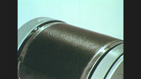 1950s: Close up, roller on copier, hands lay stencil on copier. Hands put paper Stock Footage 85827298