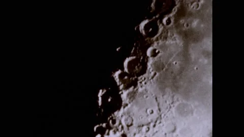 1950s: Craters on the surface of the moon. Man adjust knobs on control panel. 스톡 동영상 224165682