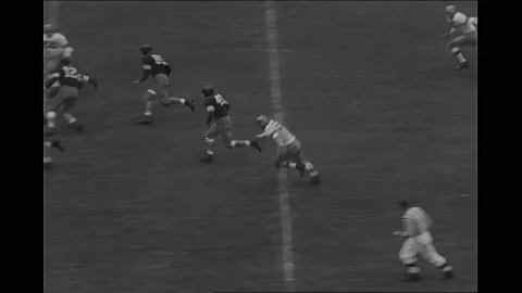 1950s: Crowd cheering and applauding. Football player running for a touchdown. Stock Footage 167099101