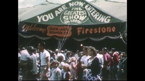 1950s: Crowd in front of Firestone circus tent / Families walk into circus tent. Stock Footage