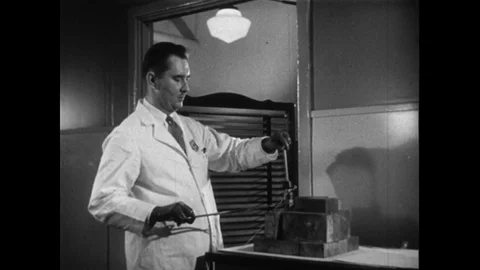 1950s: A doctor prepares and administers radioactive gallium to a bedridden Stock Footage 74428292