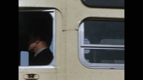 1950s: Driver on bus closes bus doors and pulls out. Interior bus: boy and his Stock Footage 165355595