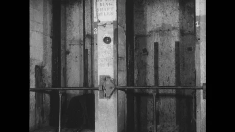 1950s: Elevator in mine carries rocks and minerals up from mine to tall building Vídeos de archivo 89264361