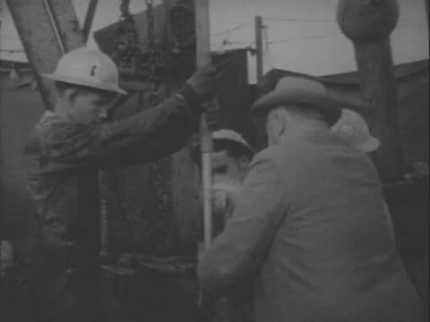 1950s - An engineer and crew use a directional drill and camera to tap an Stock Footage 82938592