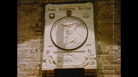 1950s: Engraved marble plaque for John Sutter. Office in historical fort. Men in Stock Footage 116857889