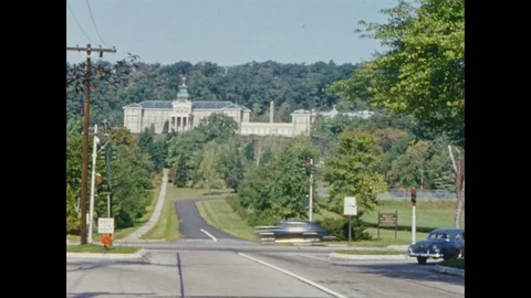 1950's: Exterior view of Mount St. Mary's Academy, modern red-brick school Stock Footage 88596259