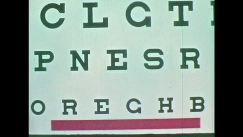 1950s: Eye test chart changing in and out of focus. Man with apron talking to Stock Footage