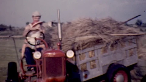 1950s Farmer Father and Son Little Boy Ride Tractor Vintage Old Film Home Movie Stock Footage