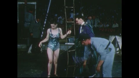 1950s: Female performer climbs up ladder at circus. Stock Footage