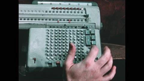 1950s: Fingers type on adding machine which moves to calculate. Stock Footage 221422641