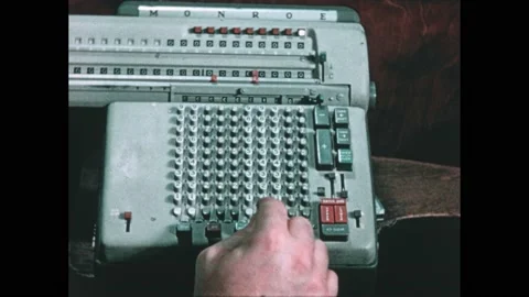 1950s: Fingers type on adding machine which moves to calculate. Stock Footage 221422649