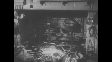 1950s: Fireplace and clutter in colonial kitchen. Ladles and spoons hang near Stock Footage 85619424