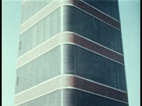1950s: Frank Lloyd Wright building. Convertible car pulls up to building, parks, Vidéo 81645106