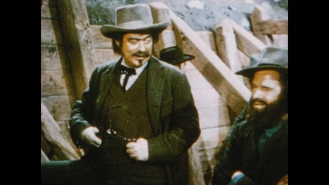 1950s: General John Sutter and man stand on steps of sawmill and talk. Stock Footage 116857931