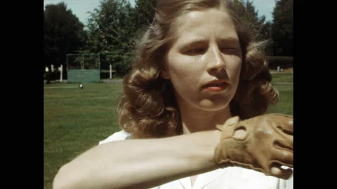 1950s: Girl practices pulling back bow and arrow slowly three times. Girl stands Stock Footage 139754081