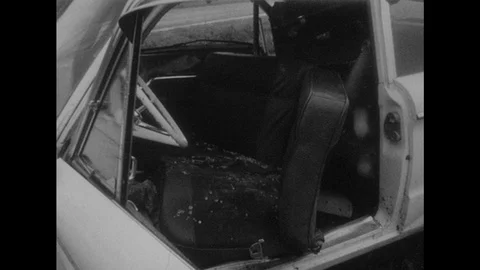 1950s: Glass Shards on Seats of Car After Accident. Road Sign. Two Cars After Stock Footage