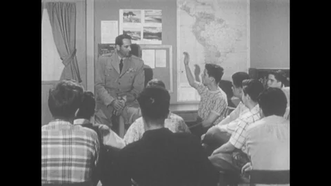 1950s: A Group Of Young Boys Meet With Army Representative To Talk. Boy Sits Stock Footage