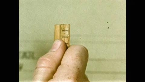 1950s: Hand grasps ruler. Window sill. Person places yardstick on windowsill. Vídeo Stock 169182527