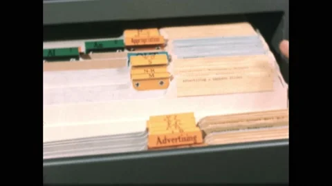 1950s: Hand opens file drawer sorted by category. "Advertising - Magazines" Stock Footage 172025058