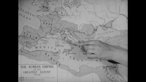 1950s: Hand with pencil points to map of  the Roman Empire. Diorama of traffic Stock Footage 124817597