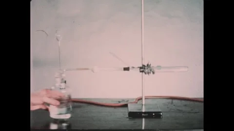 1950s: Hand points to balance scale in chamber. Hand points to laboratory Video stock 303660193