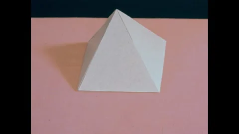 1950s: Hand sets down pyramid. Clapboard. Close up of hands with notecard, hands Stock Footage 240676719
