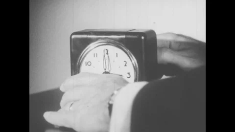 1950s: Hand turns clock pointer ten minutes back. Boss sits in his office at Stock Footage 77774266