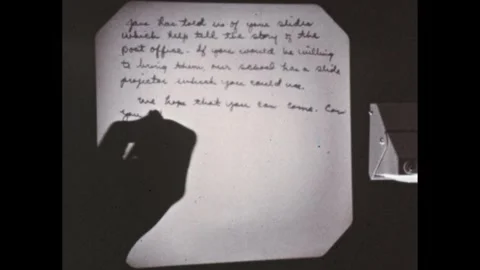 1950s: Hand writes letter of invitation on overhead projector. Stock Footage 295293242
