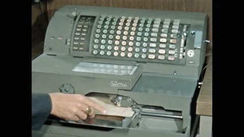 1950s: Hands operating banking machine. Stock Footage 139759485