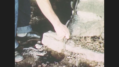 1950s: Hands pull on cable attached to cement structure. Electrical fuse box. Stock Footage 79815692