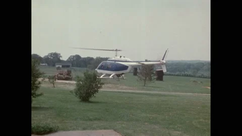 1950s: Helicopter hovering above grassy landscape. Aircraft flying over field. Vídeo Stock 188533334
