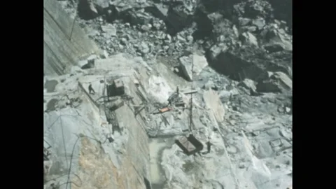 1950s: High angle, crane lowering platform, men working in mine. Shots of kids Stock Footage 172027836