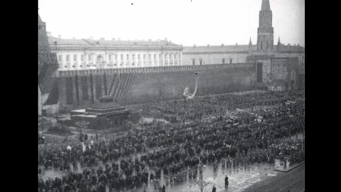 1950s: High angle view, military parade in Moscow. Soldiers march past band. Stock-Footage 112452839