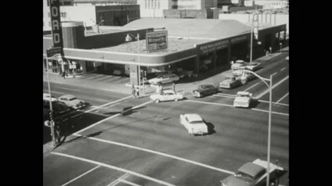 1950s: High angle view, traffic in intersection. Cars on street. Woman driving Stock Footage 168387248