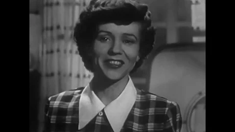 A 1950s housewife loads cookware into a Mullins dishwasher. Stock Footage