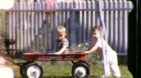 1950s KIDS Pushing Baby Brother Red Toy Wagon Vintage Film 8mm Home Movie  Stock Footage