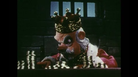 1950s: King counts gold.  Strange man appears in puff of smoke.  Man folds arms Stock Footage 84443042