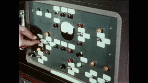1950s: Knobs turned and switches flipped on piece of equipment. Tube lifts and 스톡 동영상 220809278