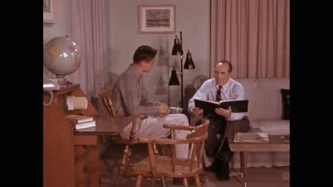 1950s: lady claps slate on set. Man gives file to boy at home. Man leans on Vídeos de archivo 219965404