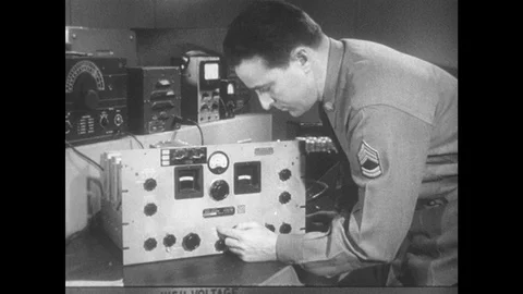 1950s: Man adjusts knobs on radio receiver. 스톡 동영상 89858305