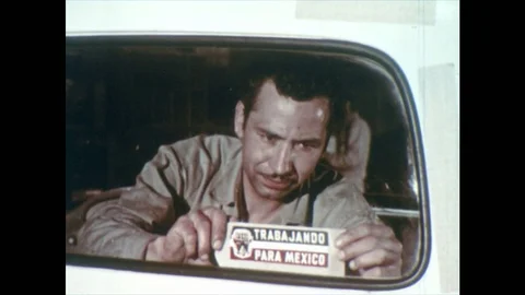 1950s: Man Attaches 'Traba Jando' certificate, Para Mexico Sign. Groups of Stock-Footage 74932934