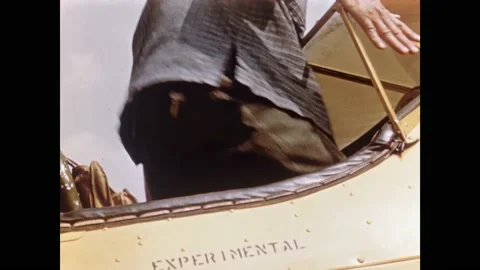 1950s: Man carefully drapes net over delicate plants, pilot prepares to enter Stock Footage 162326233
