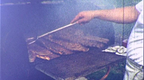 1950s Man Cooks BBQ Backyard Barbecue Ribs Smoked Meat Vintage Film Home Movie Stock Footage