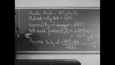 1950s: Man explaining the various points about the chemical acetic acid. Stock Footage 241508998