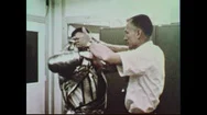 1950S- A Man Helps An Astronaut Put On His Space Suit. Stock Footage