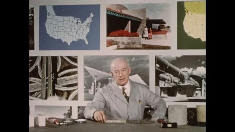 1950s: Man in lab coat stands up from table and speaks. Man smashes pillar of Stock Footage 81839251