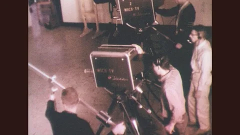 1950s: Man moves television camera forward, men monitor cameras, microphone. Stock Footage