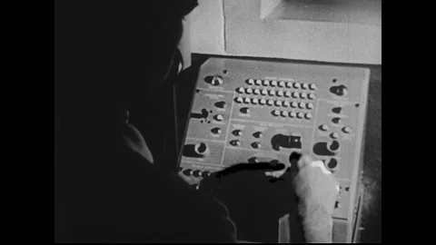 1950s: Man Presses Button on Machine as Count Down for Rocket Launch Commences Видео 74917267